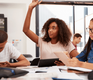 Girl raising her hand in class