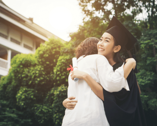 Female graduate hugging her mom